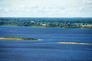 River landscape. Blue deep water with fast current. Green thickets on other coast. photo