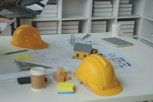 Construction and structure concept of Engineer or architect meeting for project working with partner and engineering tools on model building and blueprint in working site, contract for both companies. photo
