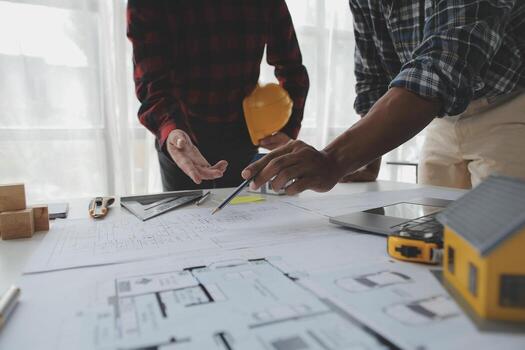 Construction and structure concept of Engineer or architect meeting for project working with partner and engineering tools on model building and blueprint in working site, contract for both companies. photo