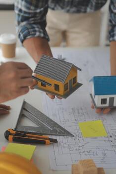 Construction and structure concept of Engineer or architect meeting for project working with partner and engineering tools on model building and blueprint in working site, contract for both companies. photo