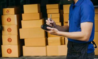 Starting small businesses SME owners female entrepreneurs Write the address on receipt box and check online orders to prepare to pack the boxes, sell to customers, sme business ideas online. photo