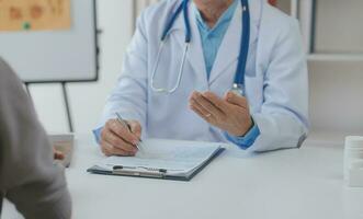 Young doctor visiting elderly woman at home photo