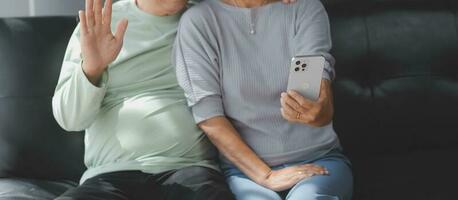 Happy mature couple using laptop at home photo