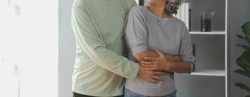 Happy mature couple using laptop at home photo