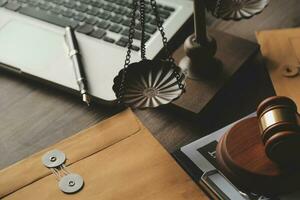 Business and lawyers discussing contract papers with brass scale on desk in office. Law, legal services, advice, justice and law concept picture with film grain effect photo