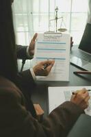 Business and lawyers discussing contract papers with brass scale on desk in office. Law, legal services, advice, justice and law concept picture with film grain effect photo