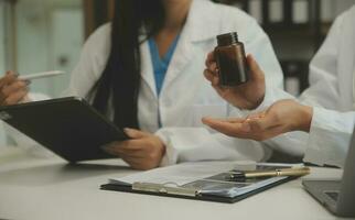 Doctor who records a patient's detailed information or medication history is evaluating medications and vaccines for the intended treatment. or if there are any side effects. photo