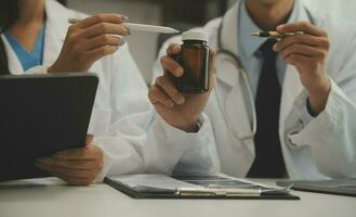 Doctor who records a patient's detailed information or medication history is evaluating medications and vaccines for the intended treatment. or if there are any side effects. photo