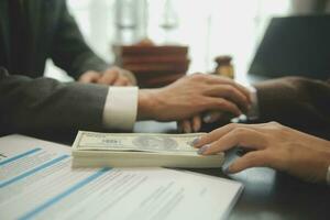 Business and lawyers discussing contract papers with brass scale on desk in office. Law, legal services, advice, justice and law concept picture with film grain effect photo