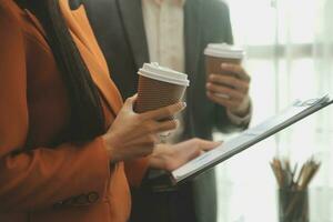 Financial analysts analyze business financial reports on a digital tablet planning investment project during a discussion at a meeting of corporate showing the results of their successful teamwork. photo