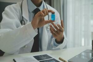 Doctor who records a patient's detailed information or medication history is evaluating medications and vaccines for the intended treatment. or if there are any side effects. photo