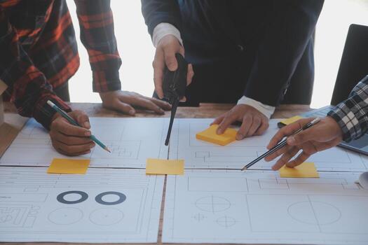 Engineer Teamwork Meeting, Drawing working on blueprint meeting for project working with partner on model building and engineering tools in working site, Construction and structure concept. photo