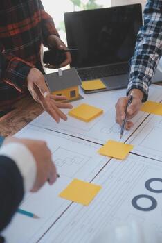 Engineer Teamwork Meeting, Drawing working on blueprint meeting for project working with partner on model building and engineering tools in working site, Construction and structure concept. photo