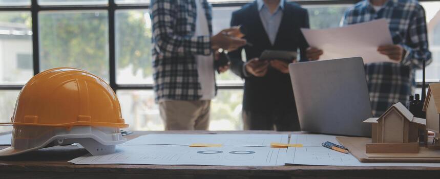 Construction and structure concept of Engineer or architect meeting for project working with partner and engineering tools on model building and blueprint in working site, contract for both companies. photo