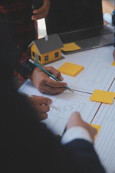 Engineer Teamwork Meeting, Drawing working on blueprint meeting for project working with partner on model building and engineering tools in working site, Construction and structure concept. photo