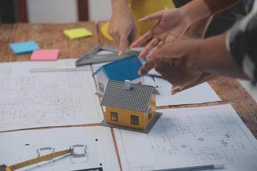 Engineer Teamwork Meeting, Drawing working on blueprint meeting for project working with partner on model building and engineering tools in working site, Construction and structure concept. photo