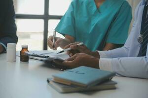 Cropped image of successful medical doctors discussing diagnosis during the conference photo