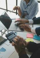 Financial analysts analyze business financial reports on a digital tablet planning investment project during a discussion at a meeting of corporate showing the results of their successful teamwork. photo