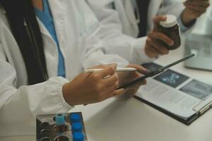 Shot of a female doctor working on medical expertise while sitting at desk in front of laptop. photo