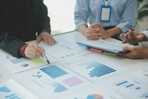 Close up of Business team analyzing income charts and graphs with modern laptop computer. Business analysis and strategy concept. photo