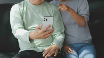 Happy mature couple using laptop at home photo