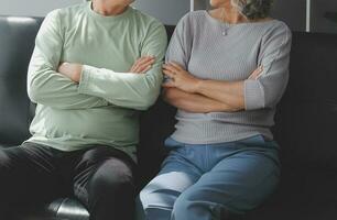 Embraced mature couple surfing the Internet on laptop at home photo