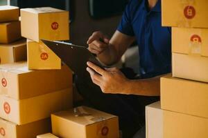 Business woman start up small business entrepreneur SME success .freelance woman working at home with Online Parcel delivery. SME and packaging deliveryconcept photo