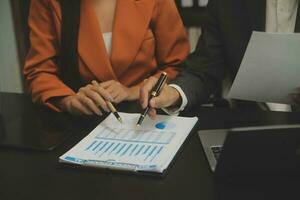 Close up Business woman using calculator and laptop for do math finance on wooden desk, tax, accounting, statistics and analytical research concept photo