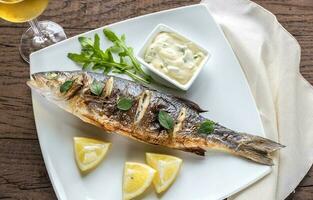 Grilled seabass on the wooden board photo