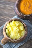 Bowls of ghee clarified butter and Indian butter sauce photo