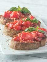 Bruschetta with cherry tomatoes and basil photo