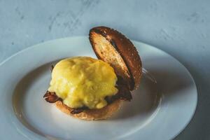 Eggs Benedict on the white plate photo