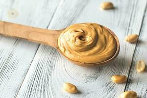 Wooden spoon of peanut butter photo