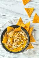 Bowl of hummus with tortilla chips photo