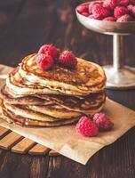 Stack of pancakes with fresh raspberries photo