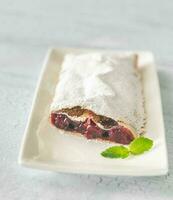 Cherry strudel on the white plate photo