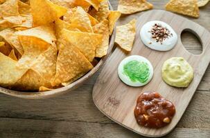 Cheese nachos with different types of sauce photo