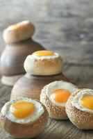 Egg-in-a-hole buns on the wooden board photo