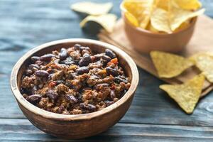 Bowl of chili con carne with tortilla chips photo