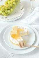 Camembert with honey, grapes and white wine photo