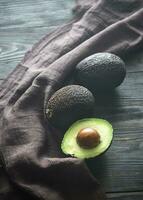 Hass avocados on the wooden background photo
