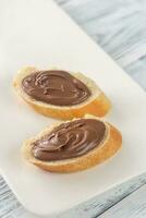 Slices of baguette with chocolate cream photo