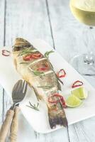 Baked sea bass with lime and chilli pepper photo