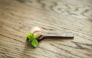 White chocolate candy in the dark chocolate spoon photo