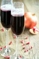 Two glasses of champagne with pomegranate seeds photo