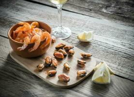 Fried shrimps and mussels with glass of white wine photo