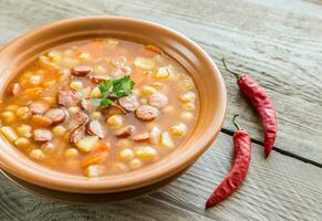 Soup with chickpeas and smoked sausage photo