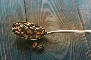 Spoon of coffee beans photo