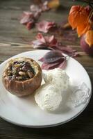 Stuffed baked apple on the plate photo