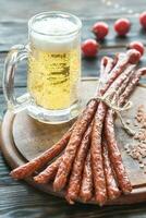 Smoked kabanosy sausages with mug of beer photo